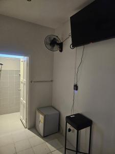 a bathroom with a shower and a fan on the wall at QG restaurant and guesthouse in Hua Hin