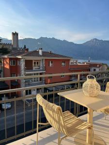 a table and chairs on the balcony of a building at Casa Nane in Malcesine