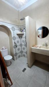 a bathroom with a toilet and a sink at Ryad Fnina in Tiznit