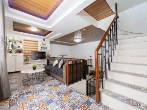 a living room with a staircase and a couch at Bella Casa (3BR House at Azienda Genova) in Talisay