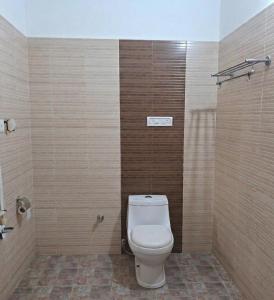 a bathroom with a white toilet in a room at Hill View Vythiri Holiday Home in Vythiri