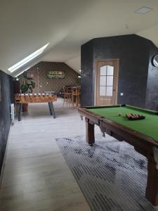 a room with a pool table in the middle of it at Apartamentai Rimkuose in Klaipėda