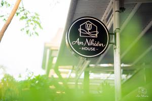 a sign for an kitchen house in front of a house at An Nhiên House in Kon Rung (1)