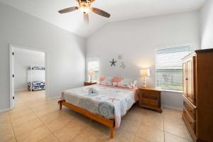 a bedroom with a bed and a ceiling fan at Spacious 5BR Pool Oasis Near Disney Resort in Sebastian