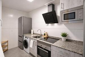 a kitchen with a sink and a refrigerator at Nova MSuites Xove in Lago