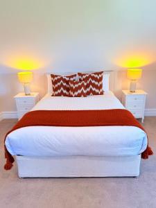 a bedroom with a large bed with two lamps at Country View House in Milltown
