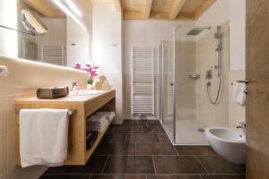 a bathroom with a sink and a shower at Hotel Moritz in Dobbiaco