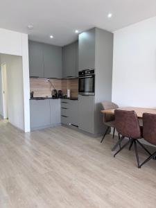 a kitchen and dining room with a table and chairs at Holiday On The Lake Lugano 5 in Bissone