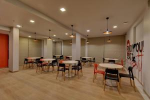 a dining room with tables and chairs in a building at Hotel Manomay in Nagpur