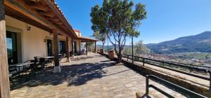 a balcony of a building with tables and chairs at Hotel Rural Atalaya in Guadalupe