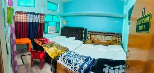 a bedroom with a bed and a table and a chair at Jagdamba home stay in Ayodhya