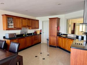 a large kitchen with wooden cabinets and a counter at Seaview Reenellen in Valentia Island