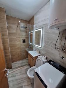 a bathroom with a toilet and a sink at Zora Apartment in Plužine +71 photos