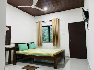 a bench in a room with a window at The Paramount Lodge & Villas in Polonnaruwa