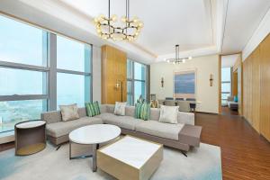 a living room with a couch and a table at Four Points by Sheraton Wuhan, Jiangxia in Wuhan