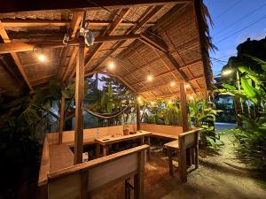 a pavilion with a table and benches under it at Jaydy hostel in General Luna