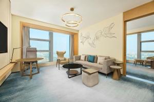 a living room with a couch and a table at Four Points by Sheraton Wuhan, Jiangxia in Wuhan