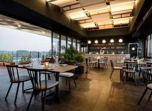 a restaurant with tables and chairs and a bar at 222 at Maine in Pretoria