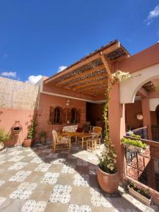 a patio of a house with a table and chairs at Ryad Fnina in Tiznit