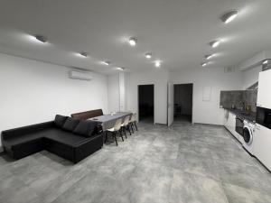 a living room with a black couch and a table at WiLDBED DE Mitte in Bad Wildbad
