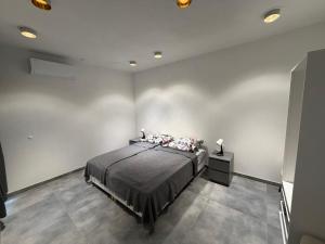 a bedroom with a bed in a white room at WiLDBED DE Mitte in Bad Wildbad