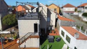 a house with a balcony on top of it at Mirador de Tambo - Campelo in Poio