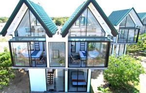 an aerial view of a house with glass windows at Pini Villa in Ampara