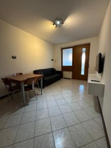 a living room with a table and a couch at Volpes home in Desenzano del Garda