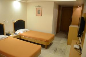 Postel nebo postele na pokoji v ubytování Hotel Yuvraj