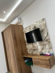 a flat screen tv on top of a wall at Hôtel Dar Farhat in Tunis