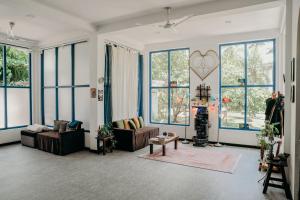 a living room with couches and windows at Phoenix house ahangama in Ahangama
