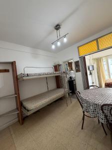 a room with two bunk beds and a table at Zona centro #N in Mar del Plata