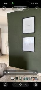 a room with a green wall with two windows at Vellora Haus in Burgersfort +6 photos