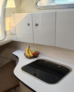a bowl of fruit sitting on a kitchen sink at HouseBoat on the river-DouroHeritage in Porto +6 photos
