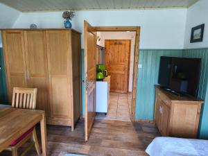 a kitchen with a door open to a kitchen with a refrigerator at Ferienhaus Sturm in Kloster