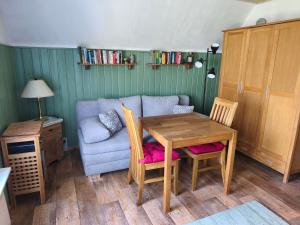 a living room with a table and a couch at Ferienhaus Sturm in Kloster