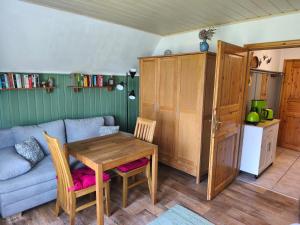 a living room with a table and a couch at Ferienhaus Sturm in Kloster