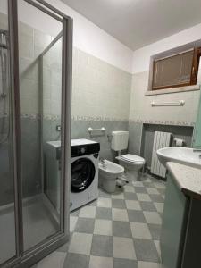 a bathroom with a toilet and a washing machine at Volpes home in Desenzano del Garda