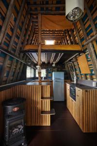 a kitchen with a stove and a refrigerator at Glampervan Rietje in Den Bosch