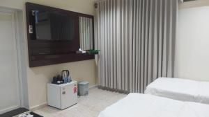 a hotel room with two beds and a television at Sanabel ALmshaan Hotel in Al Wudayy