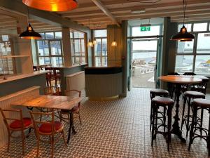 a restaurant with tables and stools in a room at The Waterfront Hotel in Baltimore