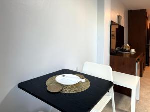 a table with a plate and two hats on it at Karon Place in Karon Beach