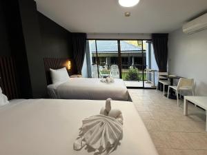 a hotel room with two beds and a balcony at Karon Place in Karon Beach +31 photos