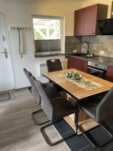 a kitchen with a wooden table and some chairs at Ferienhaus Usedom in Kamminke