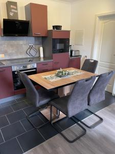 a kitchen with a wooden table and chairs at Ferienhaus Usedom in Kamminke