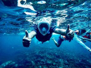 two people in the water giving the thumbs up at White Harp Beach in Hulhumale