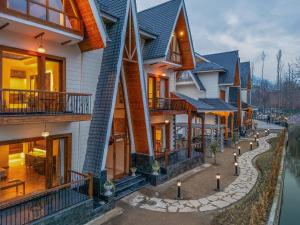a row of houses with balconies and a street at The Harmukh Hills in Batakūt
