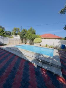 a swimming pool in a yard with a roof at Ruka Manor B&B in Strand
