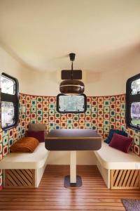 a room with two beds in a bus at Glampervan Julietta in Den Bosch