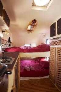 a room with two bunk beds in a kitchen at Glampervan Julietta in Den Bosch